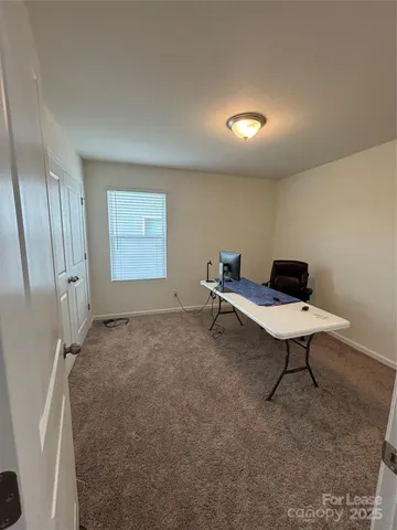 a living room with furniture and a ceiling fan