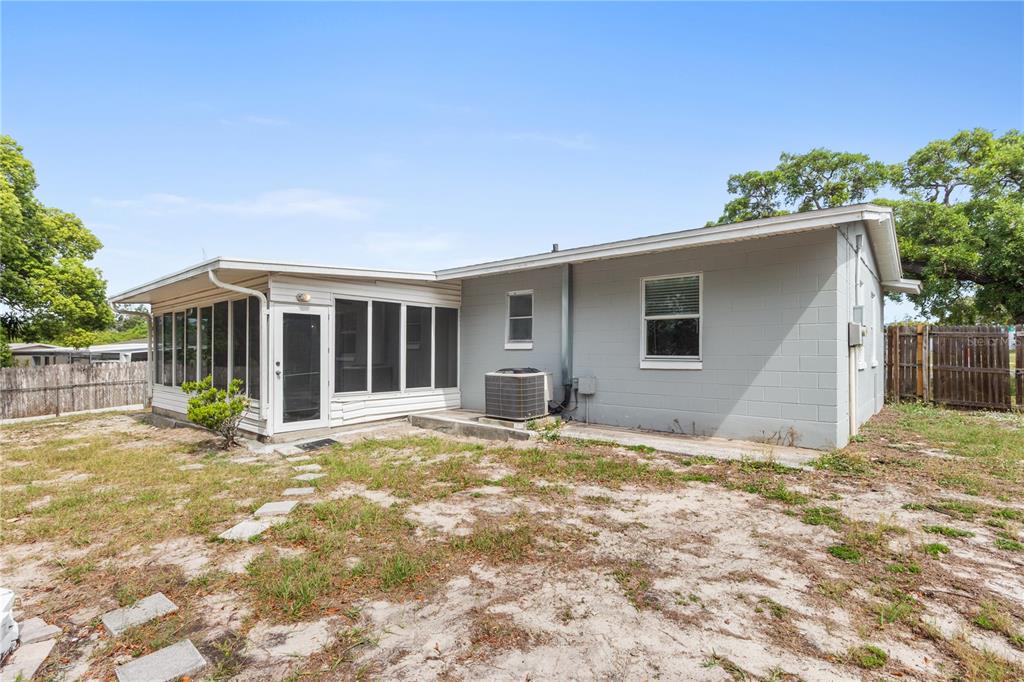 7208 Fair Oaks Street Spring Hill, FL 34606 - Photo 22 of 25 a view of house with backyard and glass windows