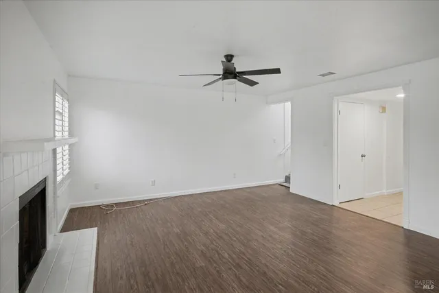 wooden floor in an empty room with a fireplace