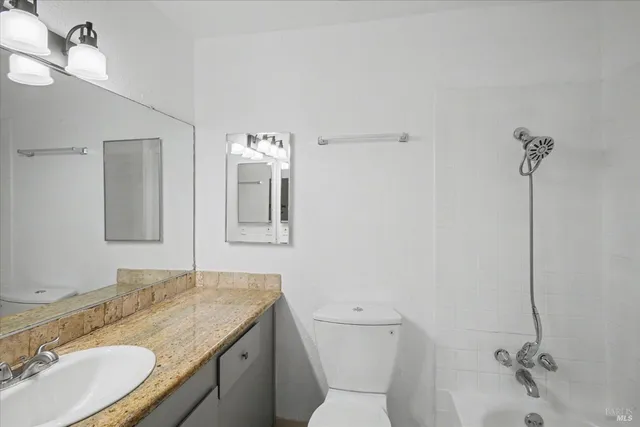 a view of a house with a large window and wooden fence