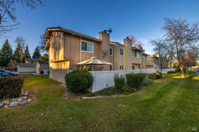 a view of a house with a yard and plants