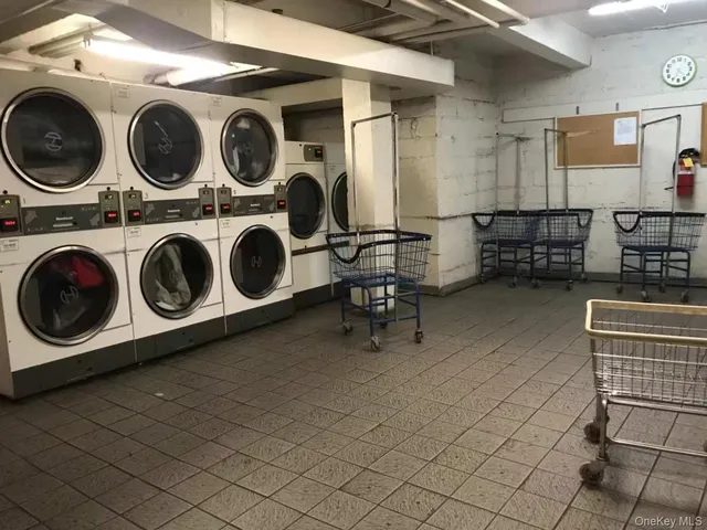 a utility room with multiple dryer and washer