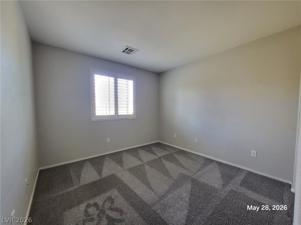 9843 West Overlook Ridge Avenue Las Vegas, NV 89148 - Photo 9 of 19 Well-lit room offering a neutral canvas and textured carpet, ready for personalization.