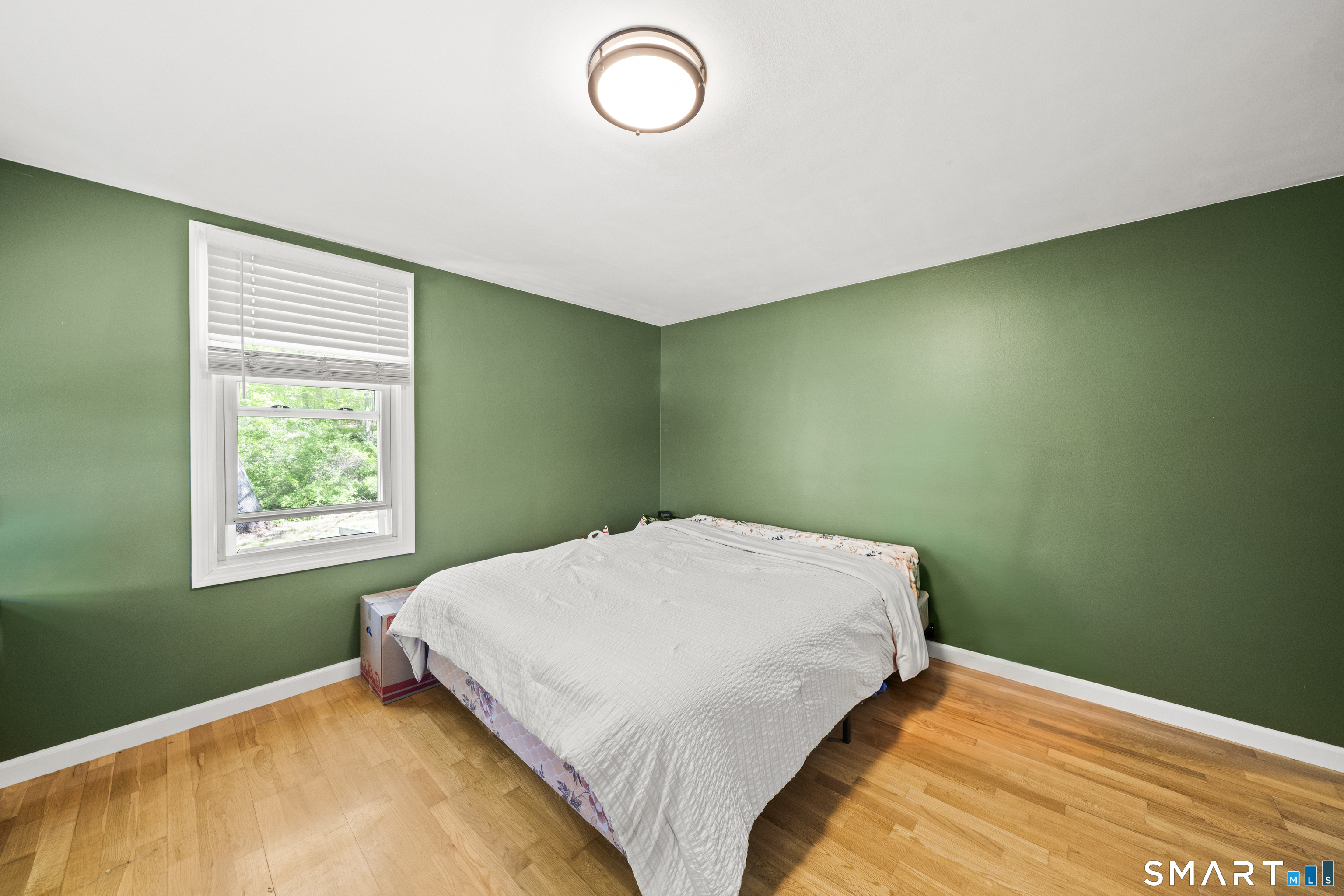 14 Church Street Sprague, CT 06330 - Photo 19 of 36 a bed sitting in a bedroom next to a window