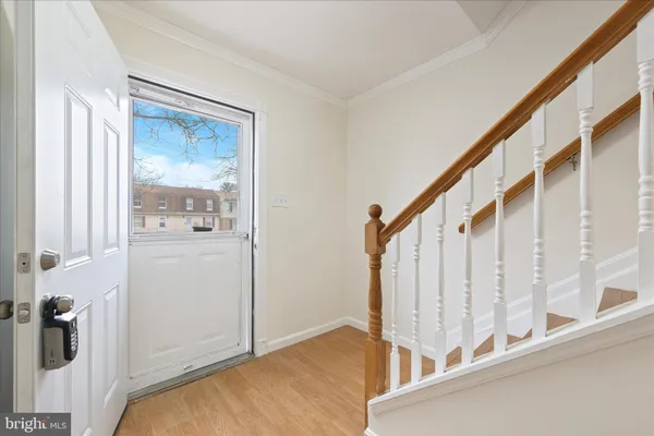 a view of entryway and hall with wooden floor