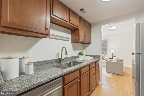 a kitchen with granite countertop a sink and cabinets