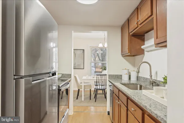 a kitchen with stainless steel appliances granite countertop a sink and cabinets