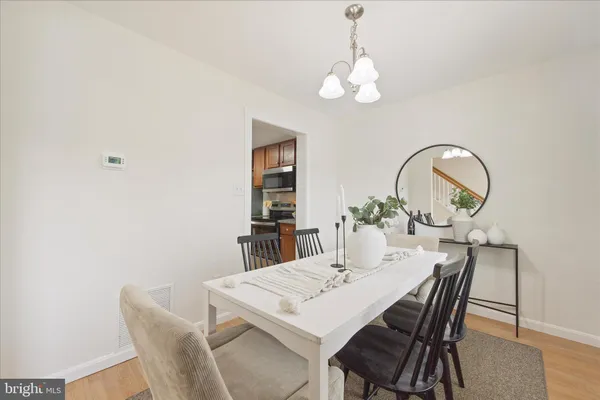 a view of a dining room with furniture and chandelier