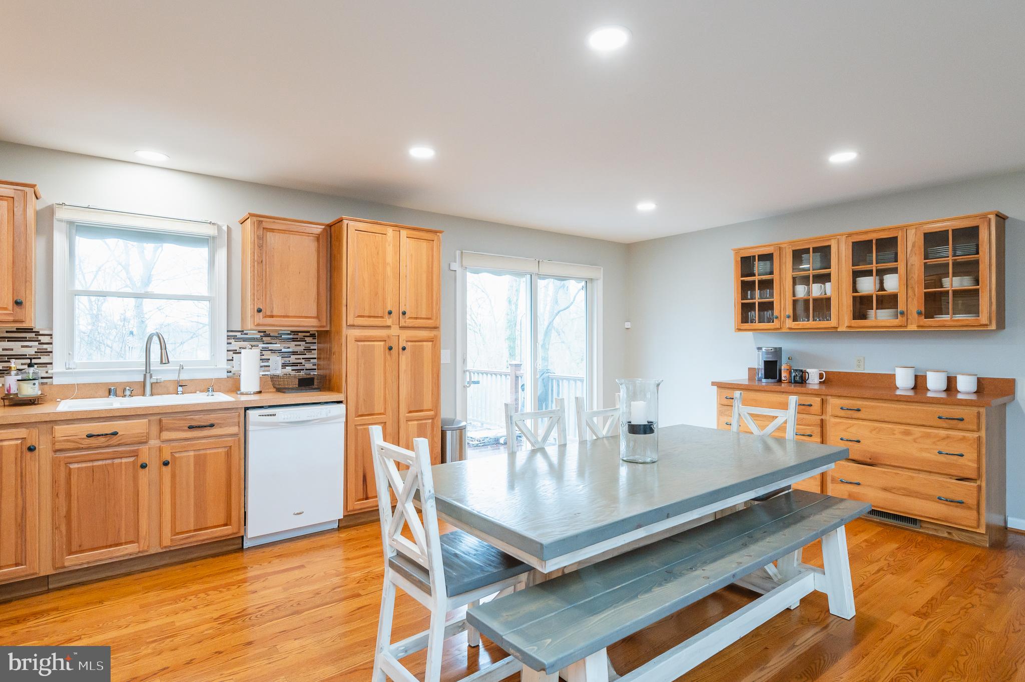 308 Cree Terrace Rising Sun, MD 21911 - Photo 15 of 51 a kitchen with granite countertop a stove a sink a dining table and chairs