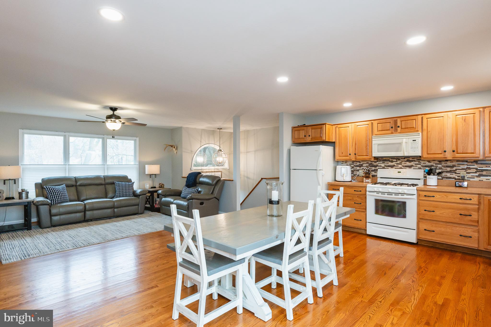308 Cree Terrace Rising Sun, MD 21911 - Photo 17 of 51 a kitchen with stainless steel appliances kitchen island granite countertop a stove a sink a dining table and chairs