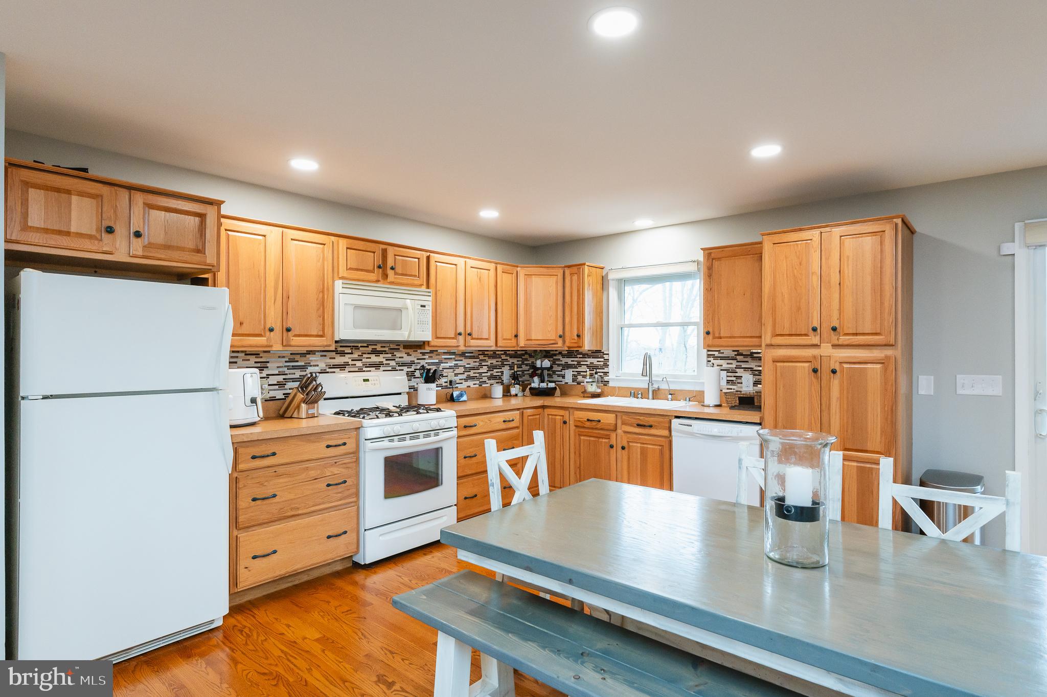 308 Cree Terrace Rising Sun, MD 21911 - Photo 18 of 51 a kitchen with stainless steel appliances granite countertop a refrigerator a sink dishwasher a stove with white cabinets and wooden floor