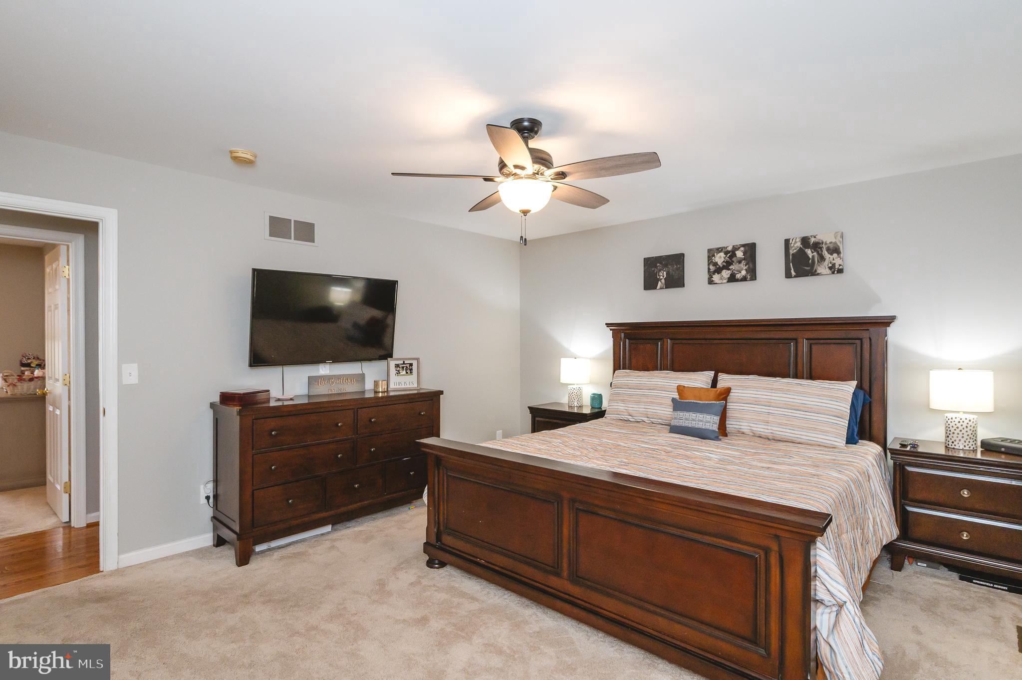 308 Cree Terrace Rising Sun, MD 21911 - Photo 21 of 51 a bedroom with a bed and a flat screen tv