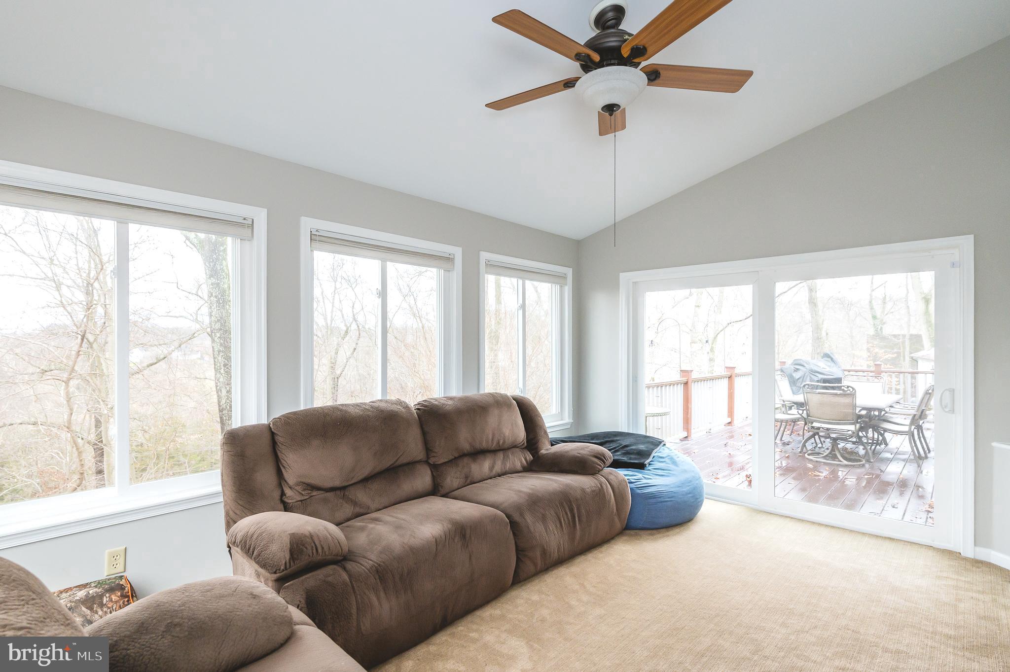 308 Cree Terrace Rising Sun, MD 21911 - Photo 33 of 51 a living room with furniture large windows and a chandelier