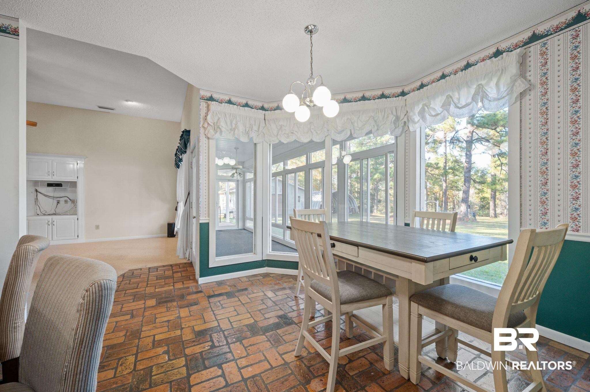 15801 Maytower Road Bay Minette, AL 36507 - Photo 17 of 43 Dining room featuring a textured ceiling, an inviting chandelier, and a wealth of natural light