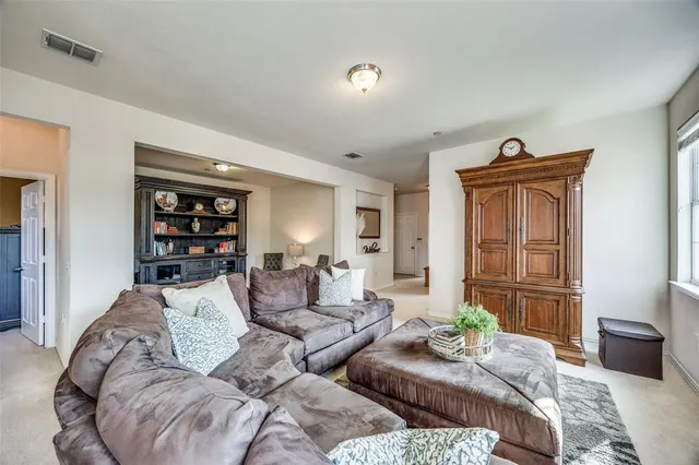 a living room with furniture and a lamp