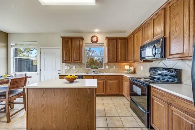 a kitchen with a stove sink and refrigerator