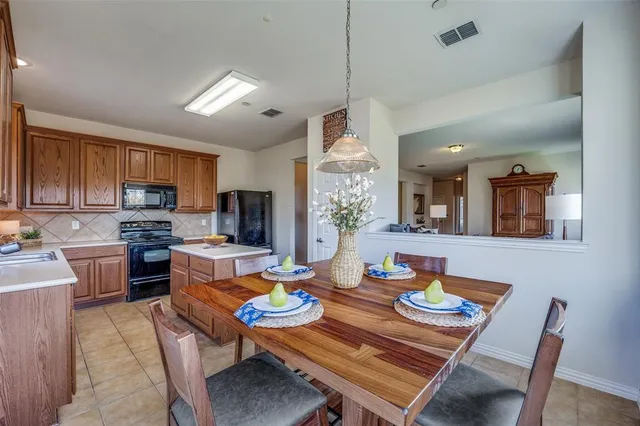 a bedroom with a bed dresser and a flat tv screen