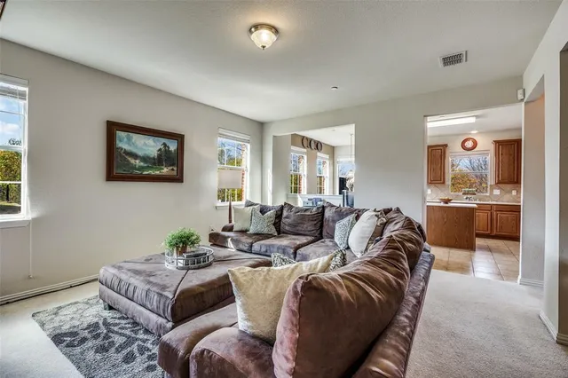 a living room with furniture cabinets and a flat screen tv