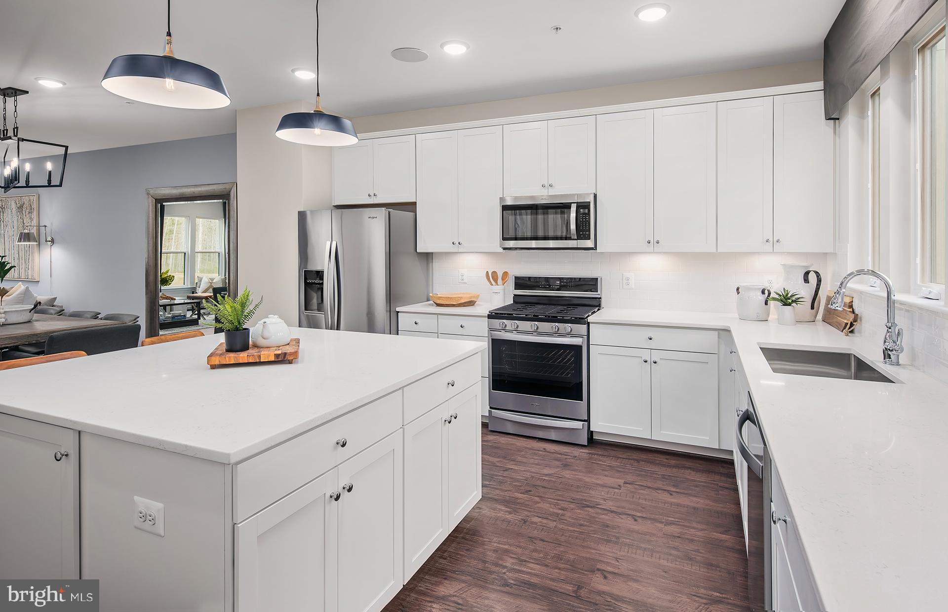 271 Freshet Lane Laurel, MD 20724 - Photo 5 of 29 a kitchen with kitchen island white cabinets and stainless steel appliances