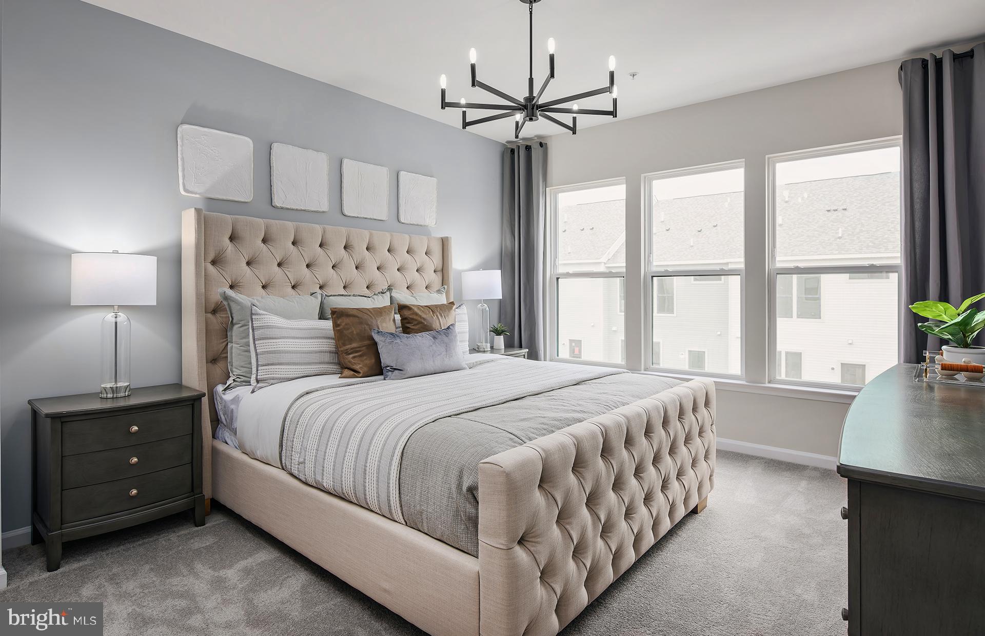 271 Freshet Lane Laurel, MD 20724 - Photo 9 of 29 a bedroom with a large bed and a chandelier