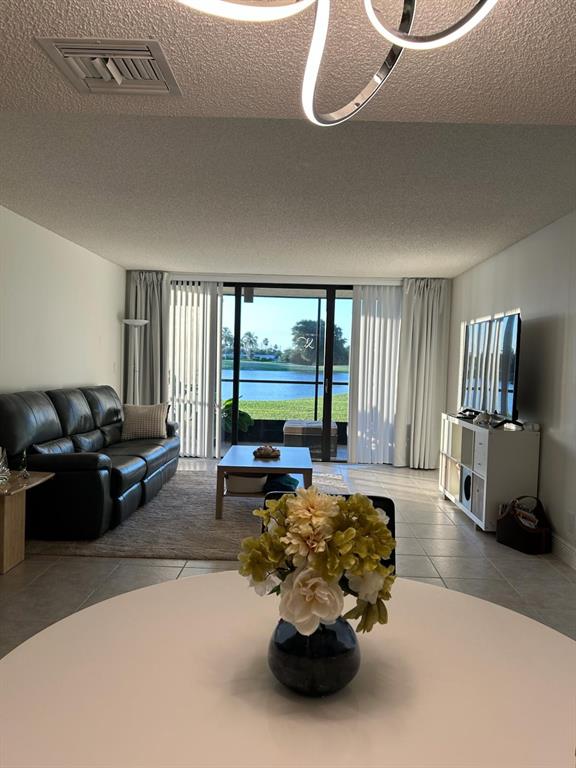 16325 Golf Club Road, Unit 109 Weston, FL 33326 - Photo 14 of 20 a lobby with furniture and floor to ceiling window