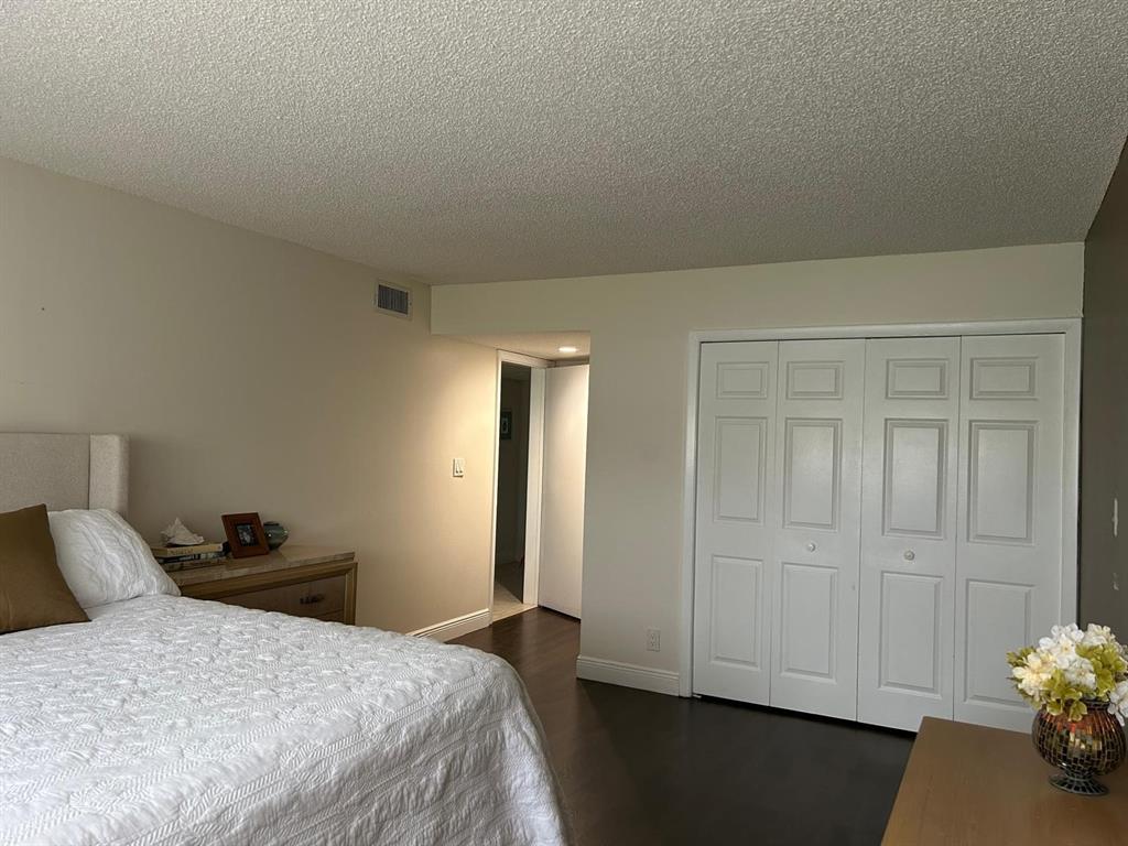 16325 Golf Club Road, Unit 109 Weston, FL 33326 - Photo 7 of 20 a bedroom with a bed and a closet