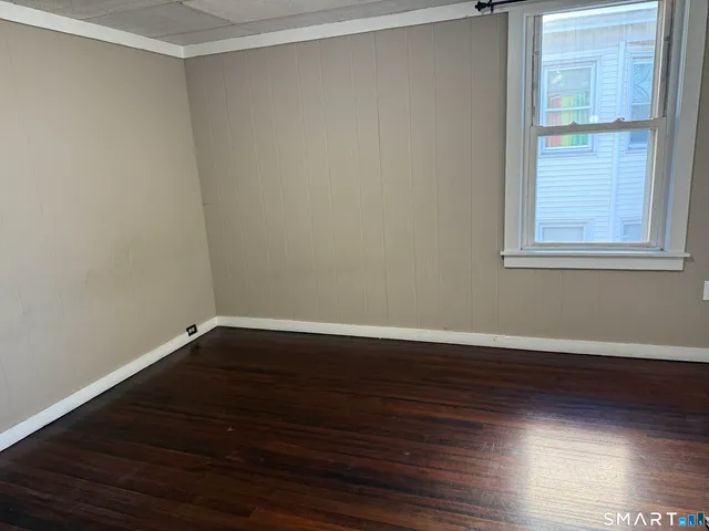 a view of a room with wooden floor and windows in it