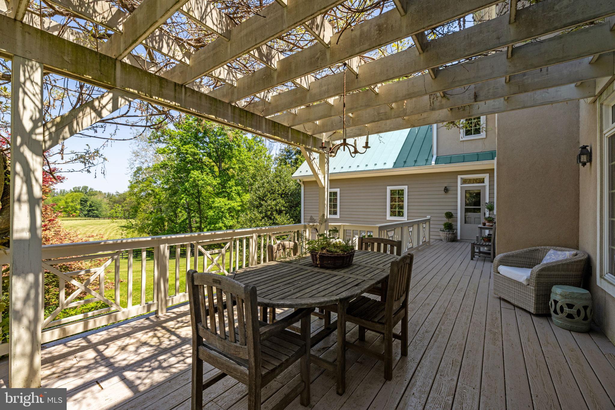 36190 Turkey Roost Road Middleburg, VA 20117 - Photo 78 of 88 a roof deck with table and chairs and wooden floor