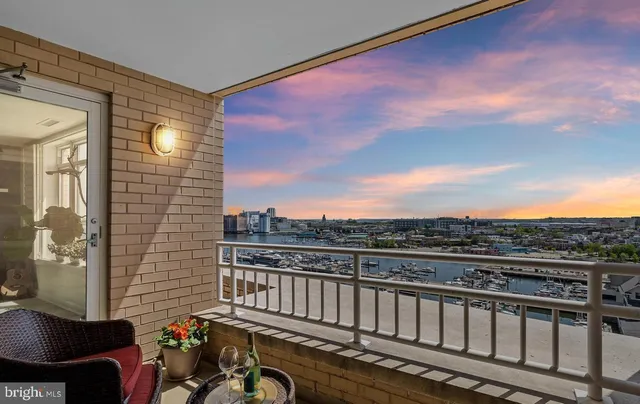 a view of a balcony with wooden floor and city view