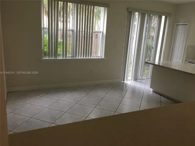 a kitchen with granite countertop a stove a sink and a microwave