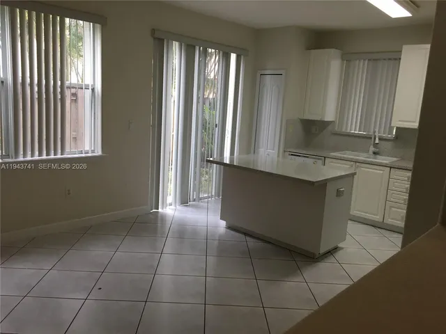 a view of room and kitchen