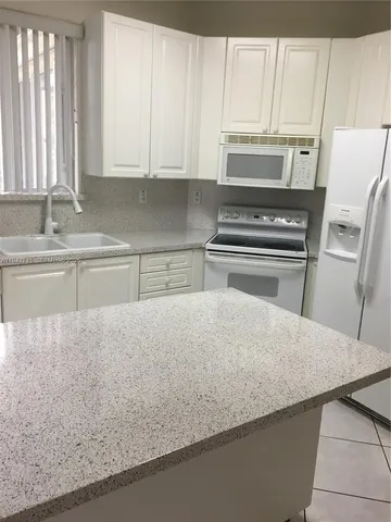 a view of a livingroom with an empty space and a window