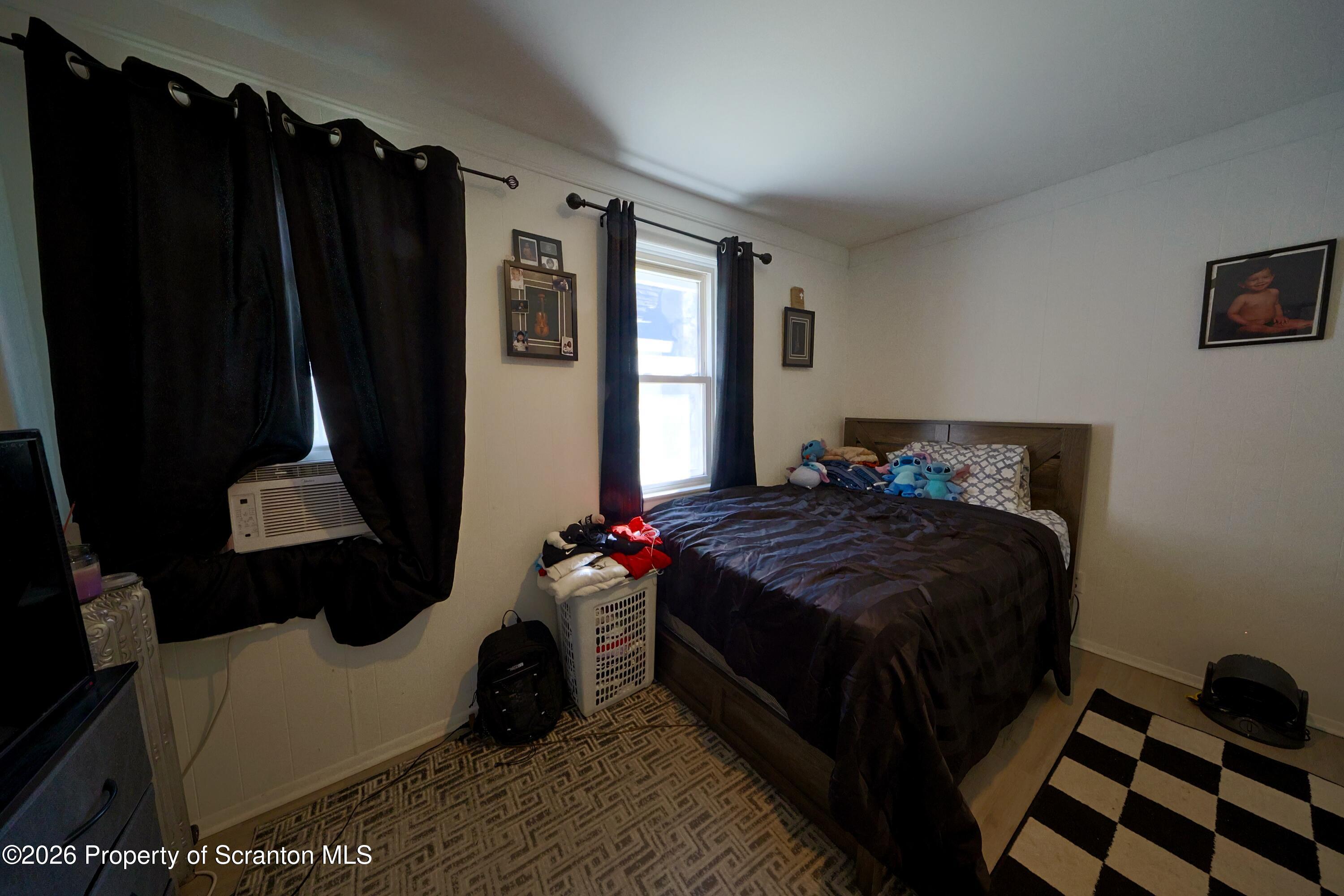 1016-1018 Diamond Avenue Scranton, PA 18508 - Photo 11 of 15 a bedroom with a bed closet and a window