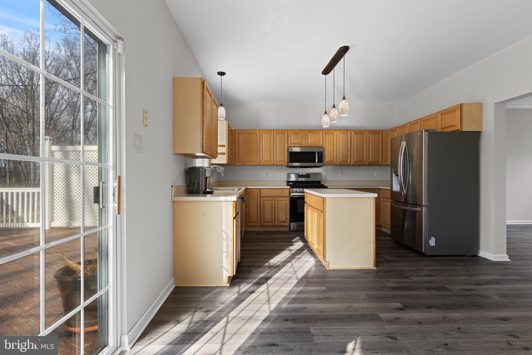 360 Yorklyn Road Oxford, PA 19363 - Photo 20 of 54 a kitchen with a refrigerator a stove top oven a sink and dishwasher with wooden floor