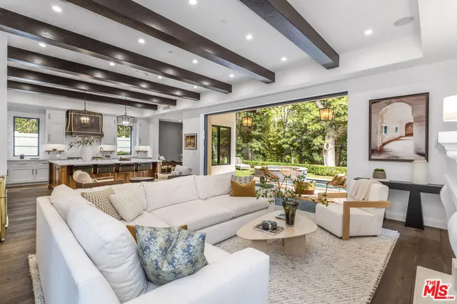 a kitchen with stove a sink a counter space and stainless steel appliances