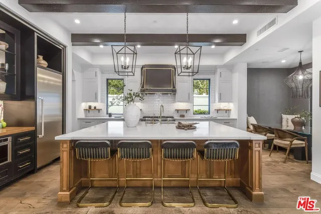 a kitchen with stainless steel appliances granite countertop a sink and cabinets
