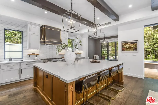 a kitchen with stainless steel appliances granite countertop sink stove top oven and cabinets