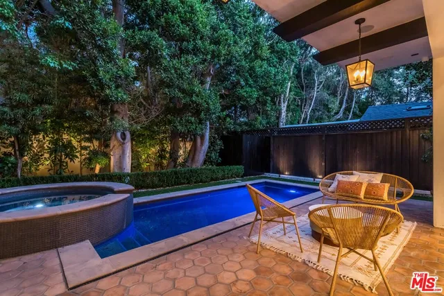 a view of swimming pool with outdoor seating and a yard