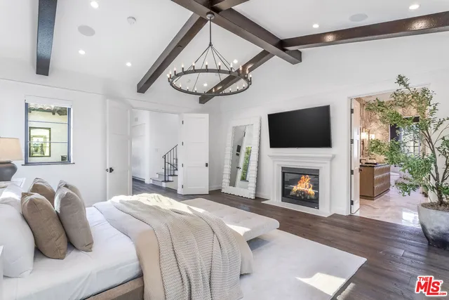 a kitchen with kitchen island white cabinets and refrigerator
