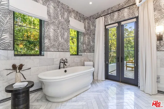 a bathroom with a granite countertop sink a mirror and a shower