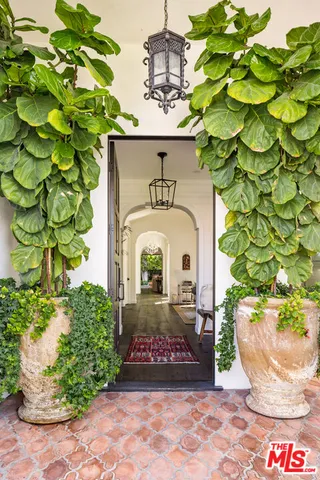 a living room with fireplace furniture and a large window