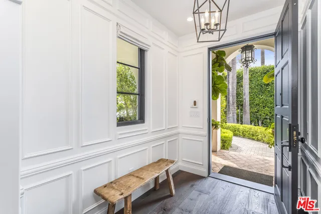 a view of a dining room with furniture a chandelier and wooden floor