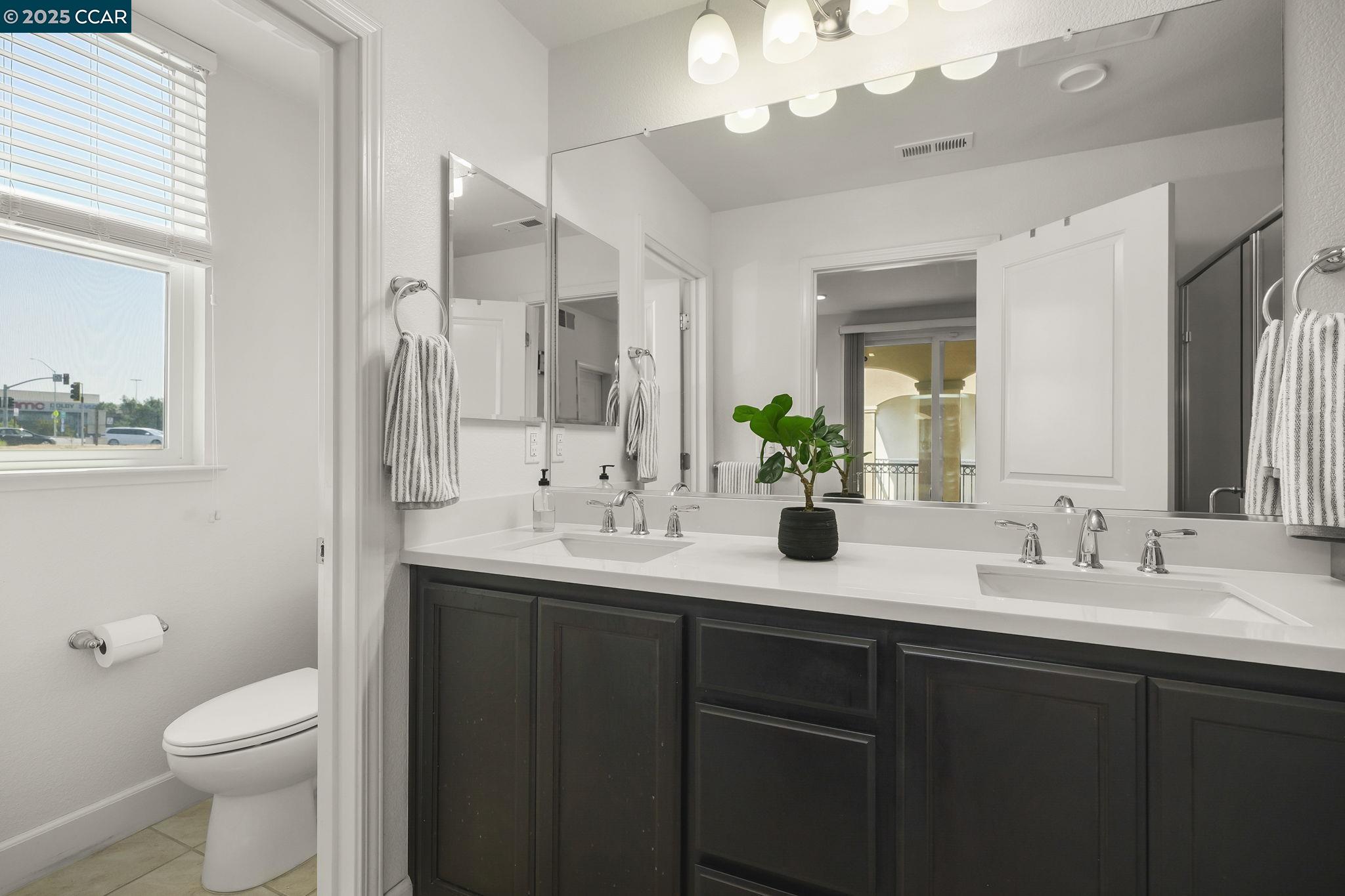 38976 Primula Terrace Newark, CA 94560 - Photo 16 of 29 a bathroom with a double vanity sink and a mirror