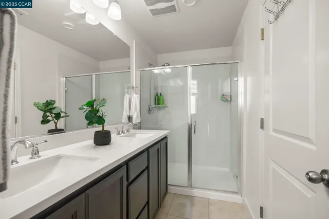 a bathroom with a granite countertop sink a shower and a mirror