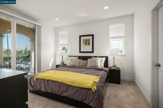 a spacious bedroom with a bed and a large window