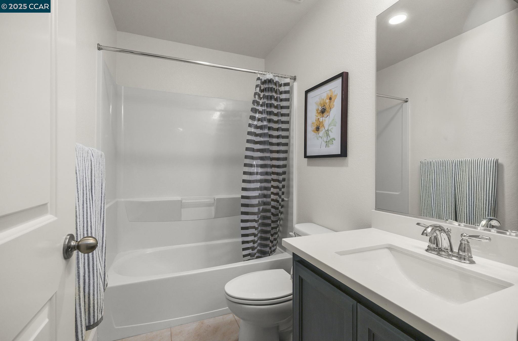 38976 Primula Terrace Newark, CA 94560 - Photo 23 of 29 a bathroom with a sink a toilet and a mirror