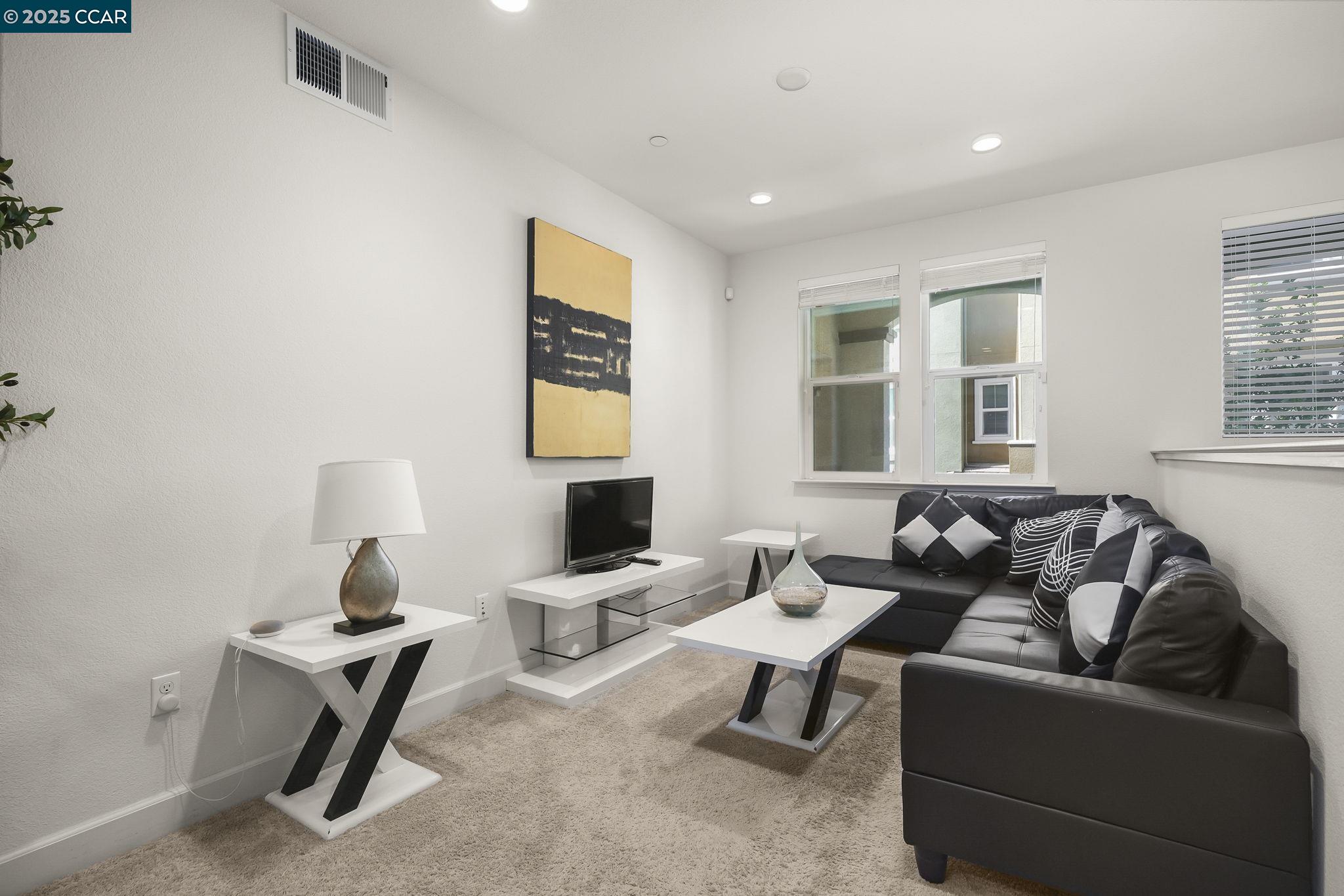 38976 Primula Terrace Newark, CA 94560 - Photo 5 of 29 a living room with furniture a lamp and a window