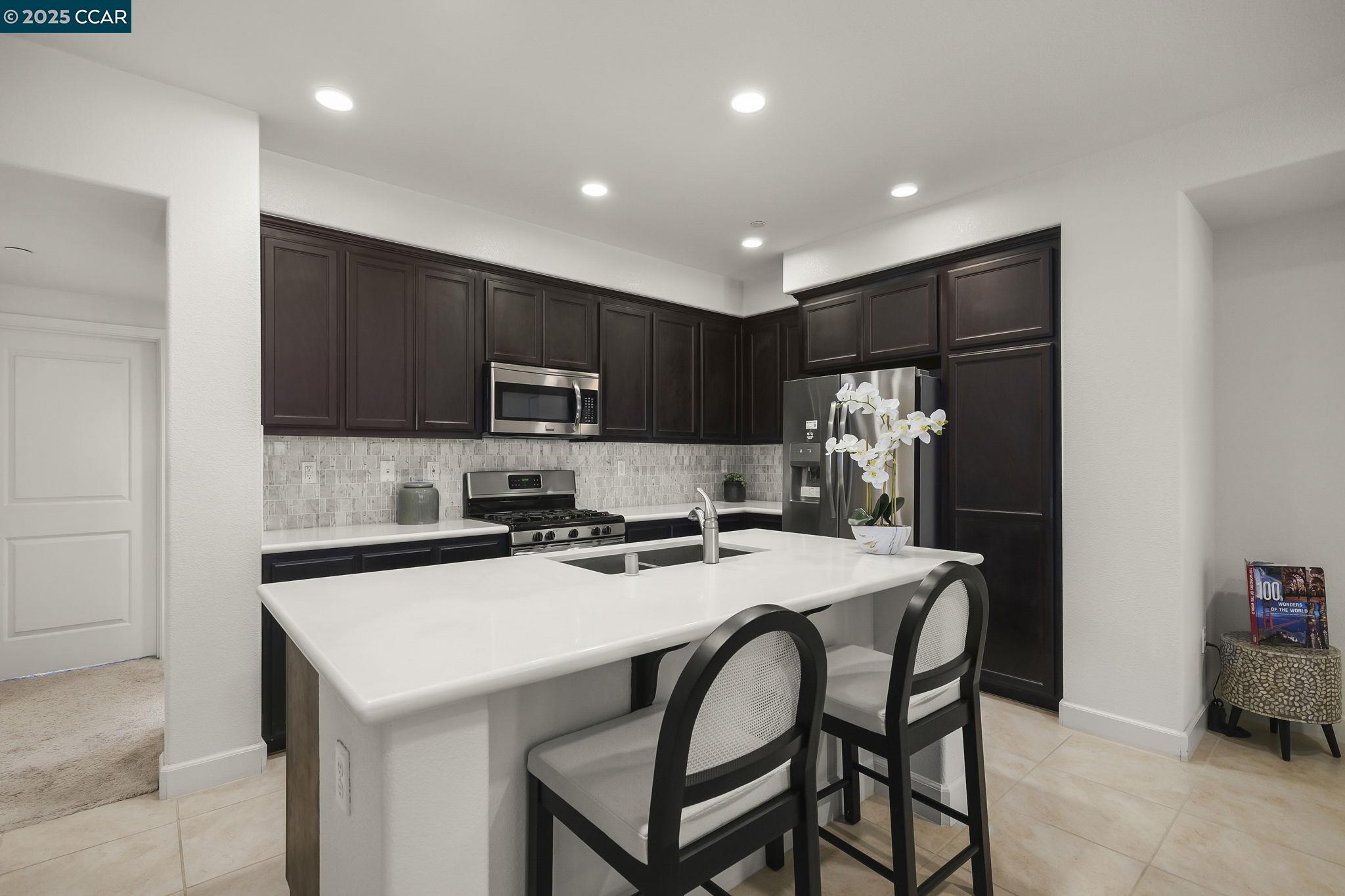 38976 Primula Terrace Newark, CA 94560 - Photo 9 of 29 a kitchen that has a cabinets and a table in it