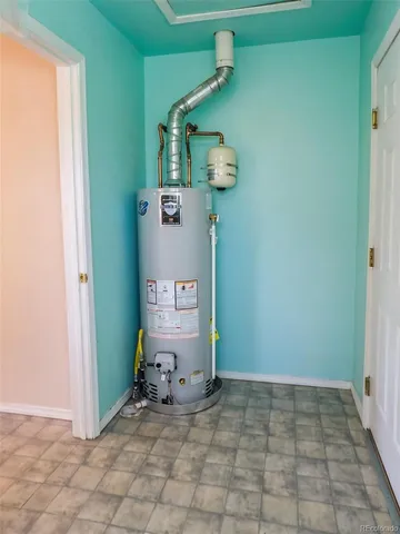 a room with water heater and a cabinet