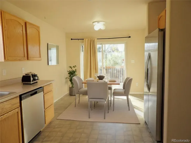 a dining room with furniture and a window